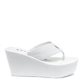 Side view of the Rocket Dog Diver white wedge flip flop, white strap on a high white wedge