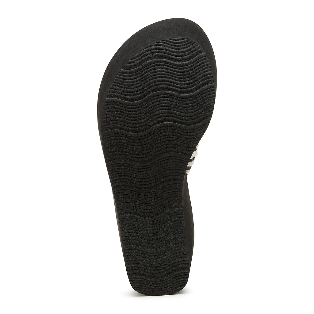 Black outsole of the Rocket Dog Crush tan animal print flip flop